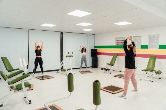 a group of people doing exercises in a gym