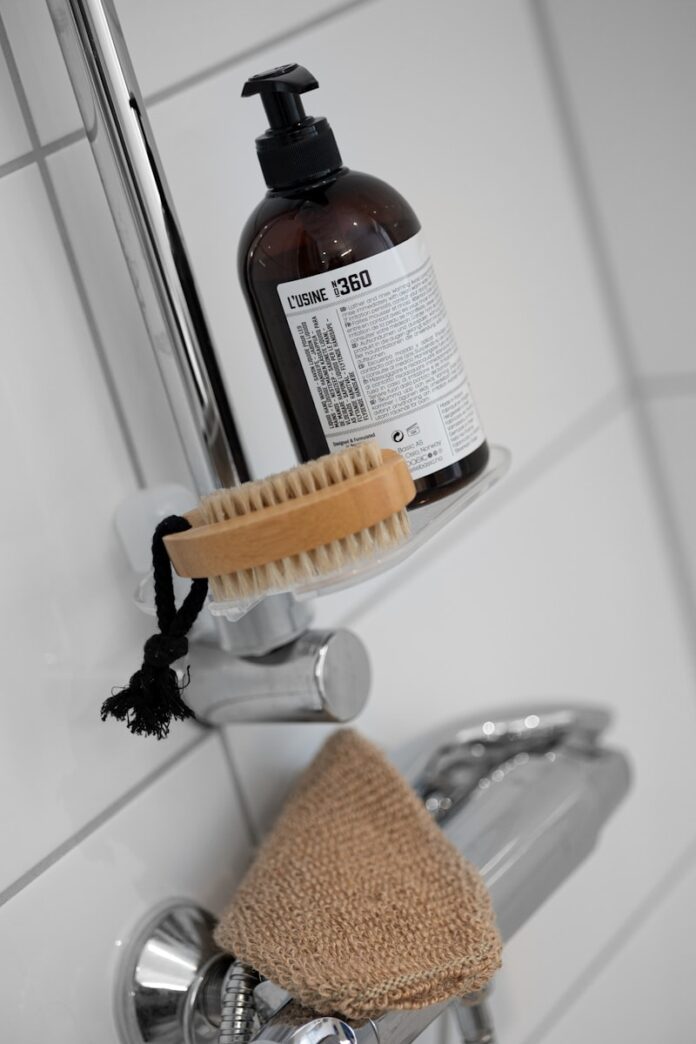 A bottle of soap sitting on top of a faucet