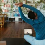 근육 잡는 건강 트렌드, 일상 속 작은 변화가 만든다 a man doing yoga in a living room