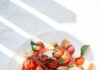 건강한 식단, 트렌드와 실천 루틴이 만나다 sliced tomato and green leaf vegetable on white ceramic plate