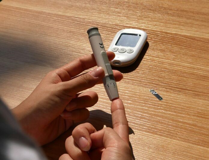 Photo by isens usa a person holding a pen and a cell phone on a table