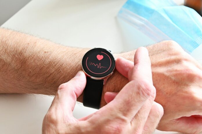 Photo by Nik A person checking a heart rate monitor on a smartwatch on their wrist